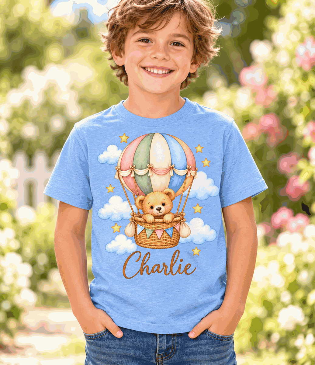 Illustrative child mockup: blue personalized teddy balloon T-shirt, Charlie sample name