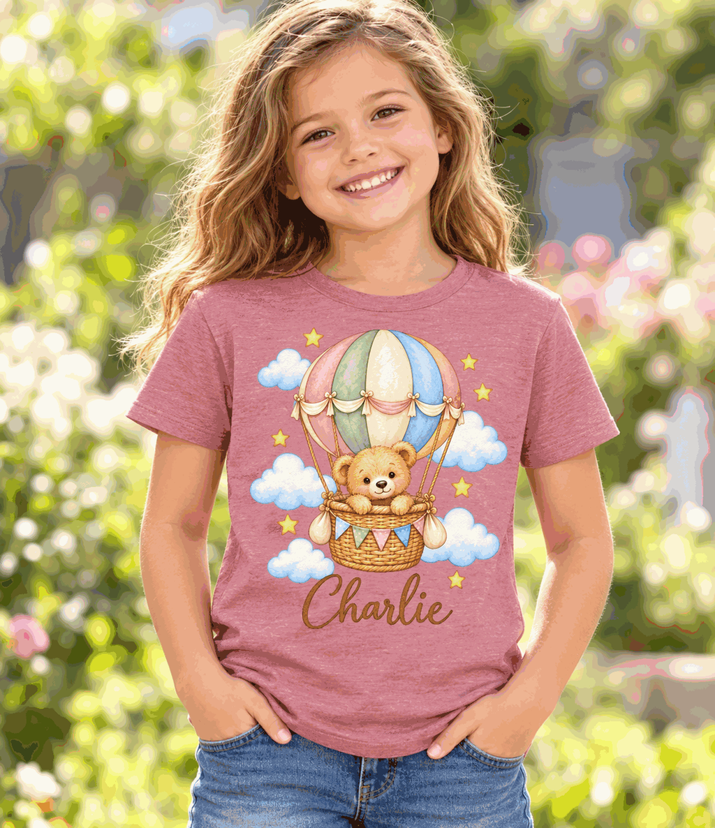 Illustrative child mockup: heather mauve personalized teddy balloon T-shirt, Charlie sample name