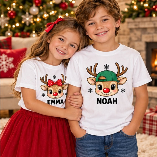 Children wearing white-family personalized reindeer head T-shirts. Each tee sold separately; names shown are samples.